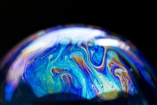 Abstract pattern, multicolored chaotic texture inside of the soap bubble, closeup photo