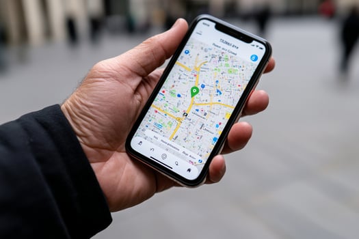 A person holding a smartphone with a map on it photo