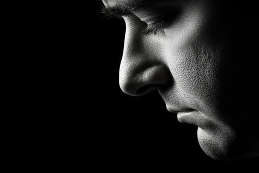 A man's face is in black and white photo