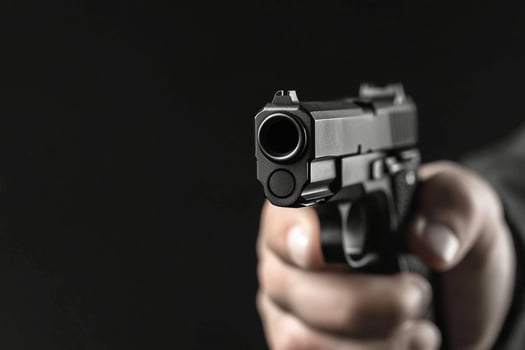 A person holding a gun in their hand photo