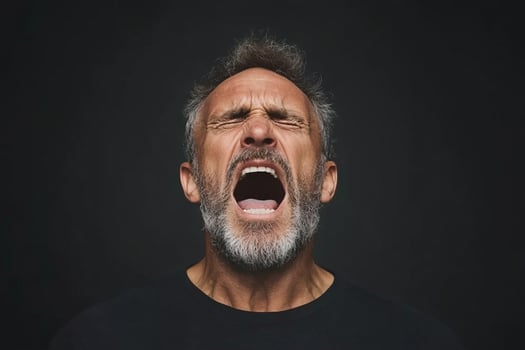 A man with a beard and a black shirt is screaming photo