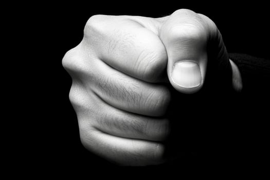A black and white photo of a person pointing their finger