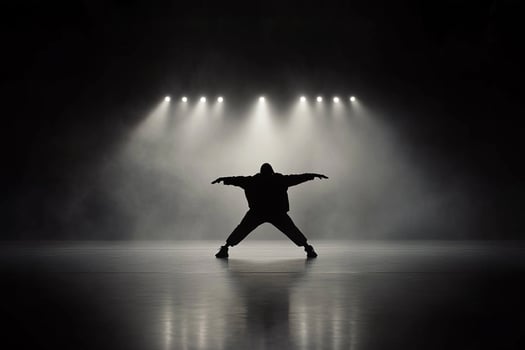 A man in silhouette standing in front of a spotlight photo