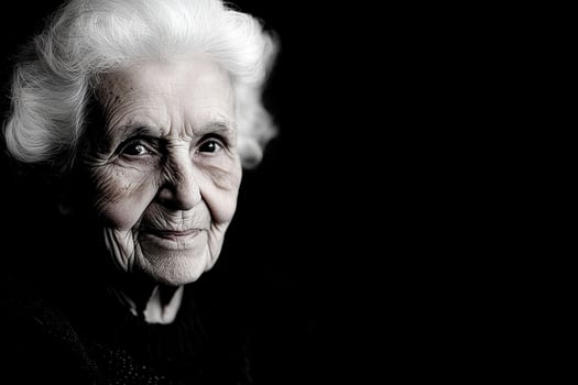 An old woman with white hair and a black background photo