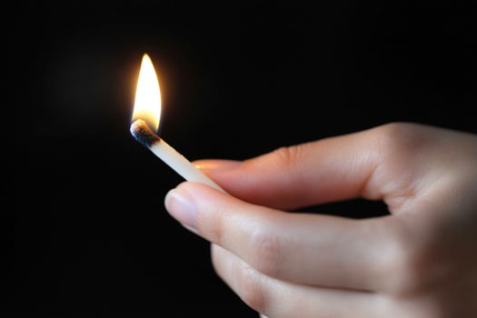 A person holding a match in their hand photo