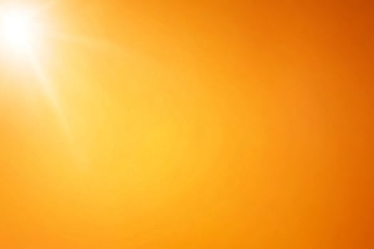 An orange sun is shining brightly in the sky photo