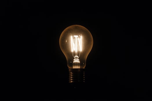 A light bulb is lit up in the dark photo