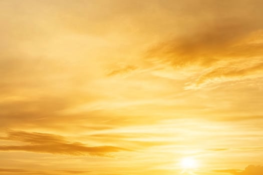 A man is standing on a hill with a large sun in the background photo