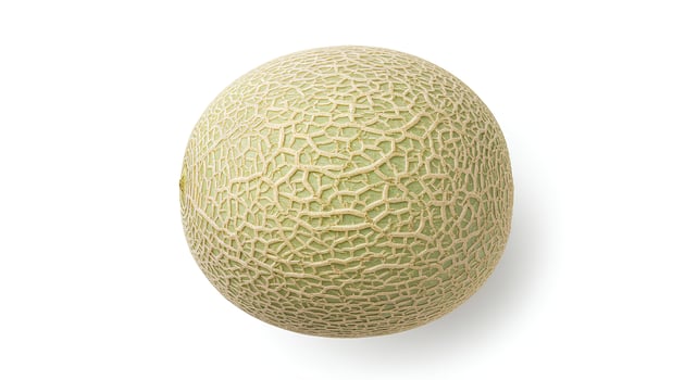 Juicy honeydew melon on white surface for detox diet, fruit salad recipes, and summer nutrition themes photo
