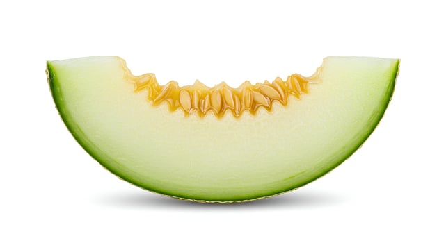 Honeydew melon with vibrant green flesh and seeds on white backdrop for vegan and wellness campaigns photo