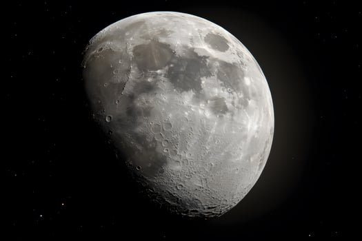 Gibbous moon glowing in the night sky, illuminating the landscape with a soft light. photo