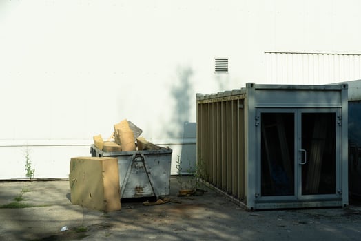 Waste Container with Foam Packaging Material on Asphalt photo