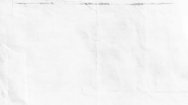 Distressed worn crumpled old paper texture in black and white for vintage design projects photo