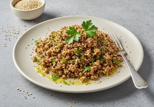 A beautifully presented quinoa salad with fresh herbs and a drizzle of olive oil on a plate. photo