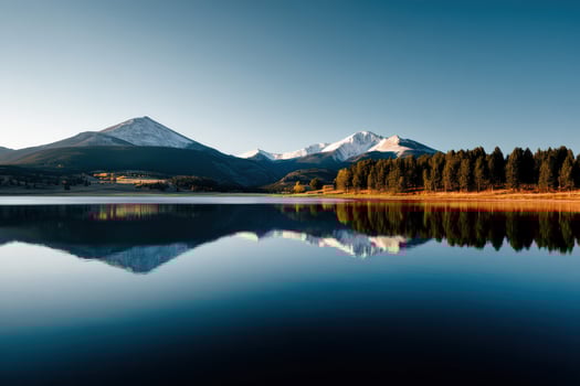 Serene reflections of mountains over calm lake water photo