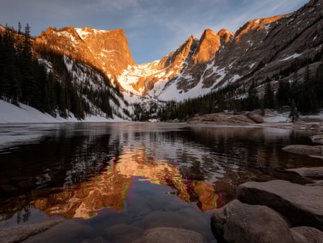 Stunning mountain lake reflecting golden sunrise light photo