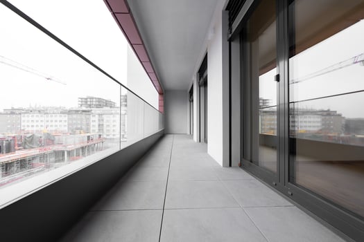 Modern city balcony with glass railing and urban construction view photo