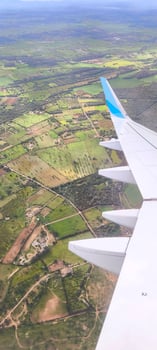 Landscape under the wing of an airplane during flight photo