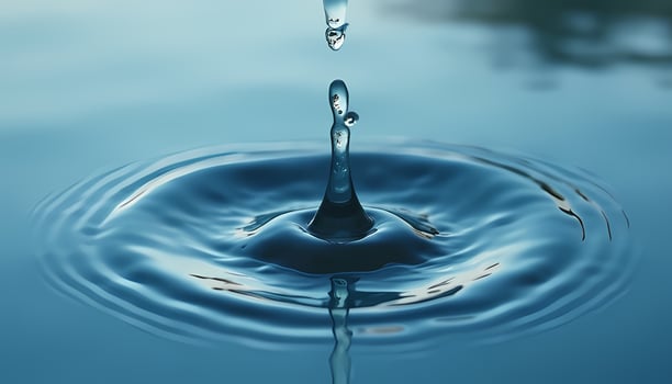 Water Drop Splash and Ripples in Blue Water photo