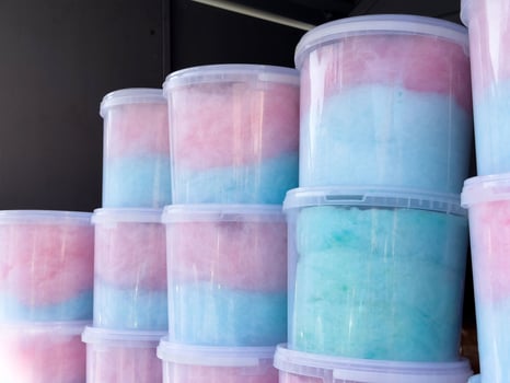 Stacks of colorful cotton candy in clear plastic containers photo
