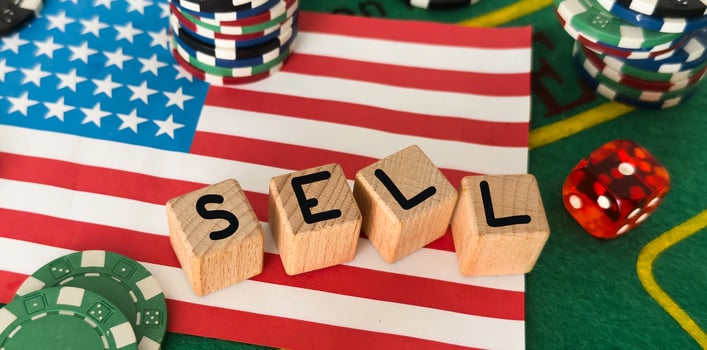 word sell, gambling chips and dice, US flag photo