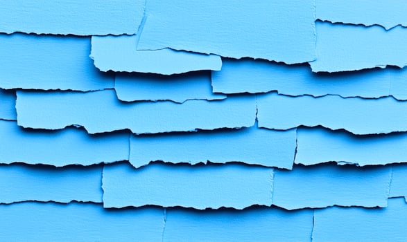 A blue wall with torn paper on it photo