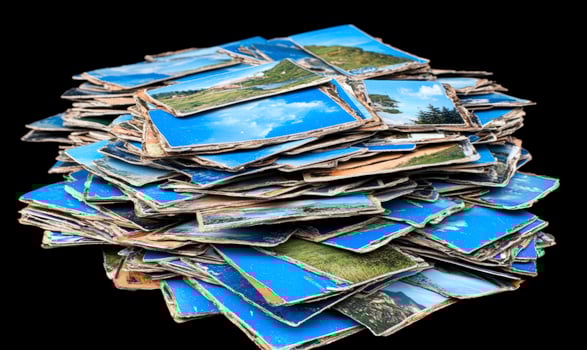 A pile of old photos on a black background
