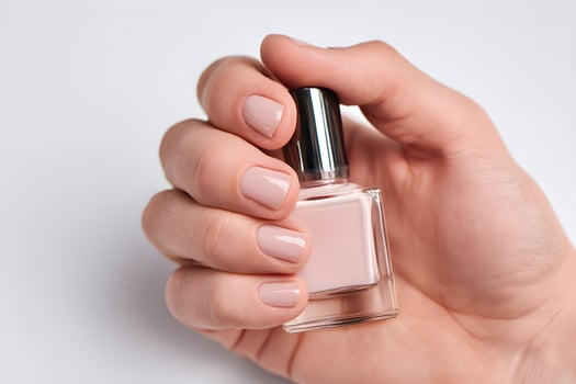 Elegant manicure showcases soft pink nail polish in male hand, highlighting attention to detail and personal care photo