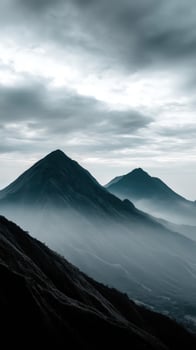 Mountain peaks rise through misty clouds at dawn photo