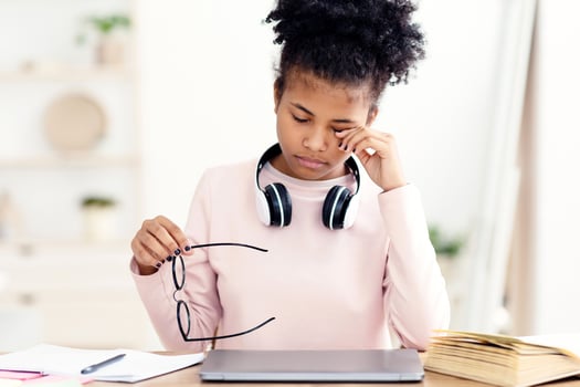 Eyesight Problem. Tired Black Teen Girl Touching Aching Eye Holding Eyeglasses Sitting At Laptop At Home photo