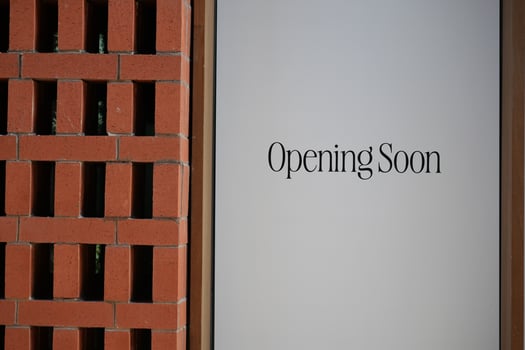 New establishment announcing grand opening in urban area photo