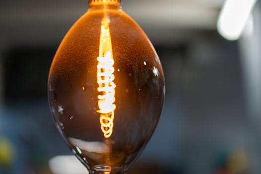 Decorative antique style filament light bulb glowing photo