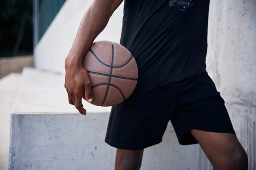 Close up view. Young black man is with baske,tball ball outdoors photo