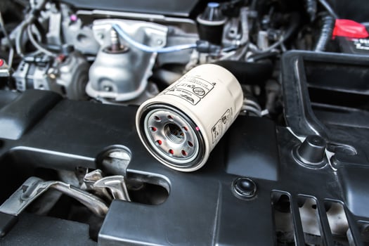 Oil filter cartridge of car on engine bay. Automotive part, engine care. photo