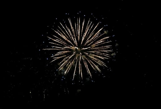 Stunning firework display against a dark night sky. Golden sparks radiate outwards, creating a vibrant, celebratory image perfect for holiday cards, websites, or celebratory event marketing. photo