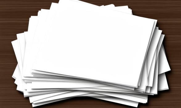A stack of blank paper on a wooden table photo