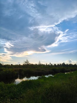 A view of a river and some clouds photo