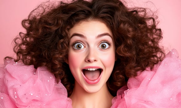 A woman with curly hair and pink dress photo