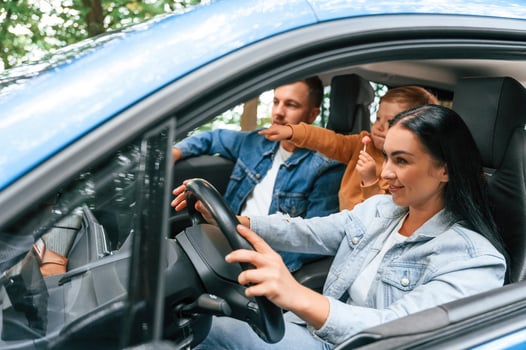 Cheerful ,people driving., Family of father, mother and little son are sitting in the modern car photo