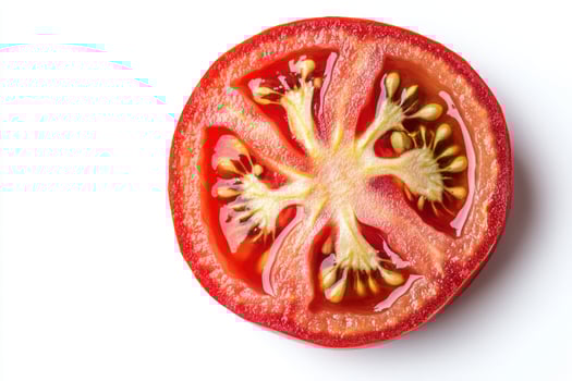 a tomato cut in half on a white background photo