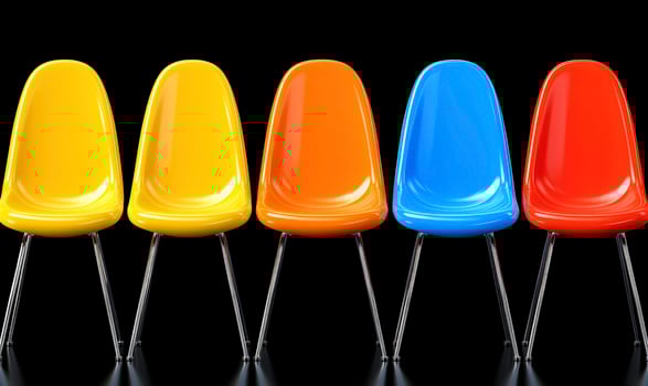 Colorful Plastic Chairs in a Row Against a Black Background, Bright Yellow, Orange, Red and Blue Modern Seating for Contemporary Spaces, Minimalistic Design photo
