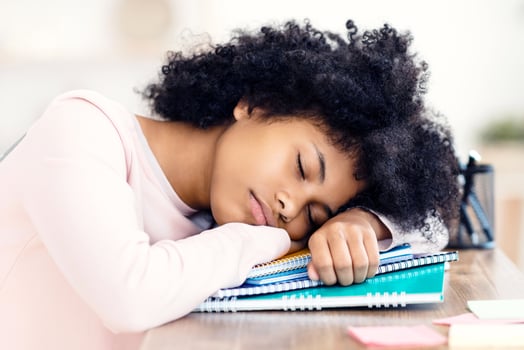 Overworked Black Teen Girl Sleeping During Class Resting Head On Books Indoors. Burnout In School photo