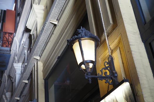 Charming vintage street lamp hanging outside a European building photo