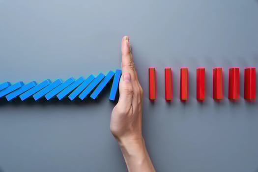 Interrupting the Fall A Hand Stops the Domino Effect photo