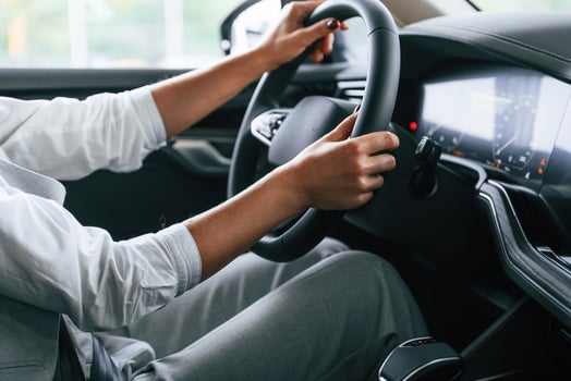 Modern quality, interior. Woman is sitting in a car and driving it photo