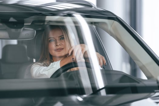 Front view,, driving. Woman is sitting in a car photo