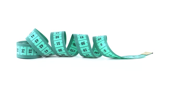 A coiled turquoise measuring tape lies on a white surface, ready for precise tailoring. photo