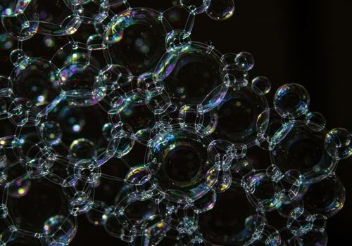 A mesmerizing arrangement of connected soap bubbles with rainbow reflections. photo