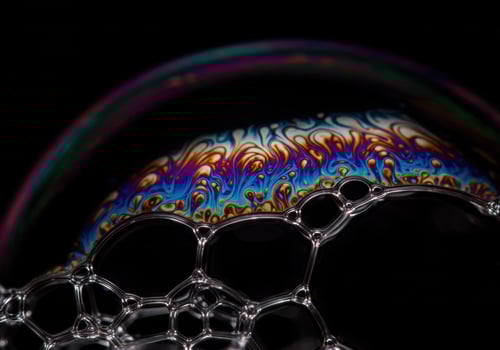 Vibrant colors dance across a soap bubble surface, creating a mesmerizing, detailed display. photo