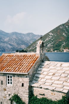 Ancient stone church of Our Lady of the Angels with a belfry on the roof. Donji Stoliv, Montenegro photo